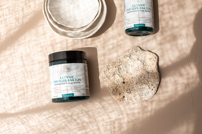 Phytality vegan omega 3 supplement capsules and phytoplankton powder on a clean background